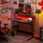 Secretária Gaming com Luzes LED 100x60 cm Tomadas de Corrente Suporte para Monitor Prateleiras e Comando Remoto Preto